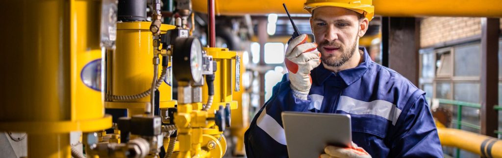 Industrial worker inspecting electrical panel.